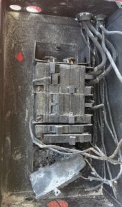 A Burnt Electrical Panel After An Electrical Fire—Showing Why An Electrical Panel Upgrade Is Essential To Prevent Damage And Keep Your Home Safe..