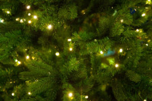 Holiday String Lights On A Christmas Tree, Highlighting Electrical Safety And Preventing Fire Hazards.
